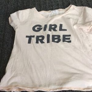 A pinkish t shirt that day girl tribe on it